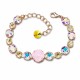 Aproce „Apžilbinošs Mirdzums II (Rose Water Opal / Aurora Borealis / Golden Shadow)“ ar Swarovski™ kristāliem